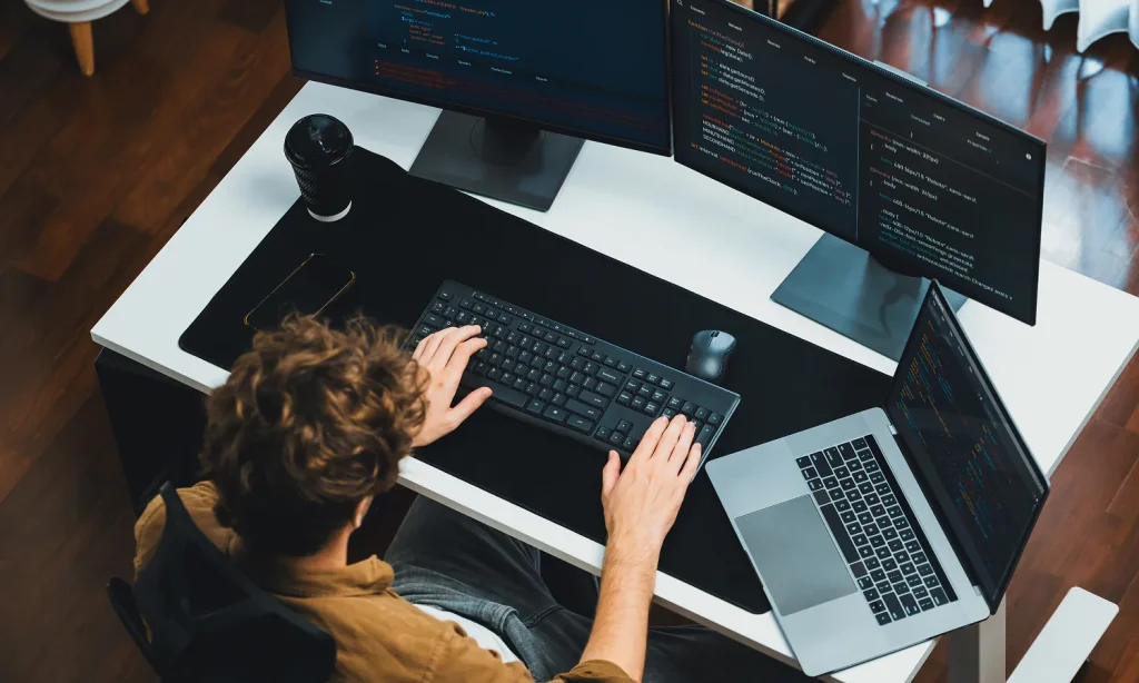 A focused student working at a desk with a laptop and notes, representing common productivity mistakes and how to improve progress